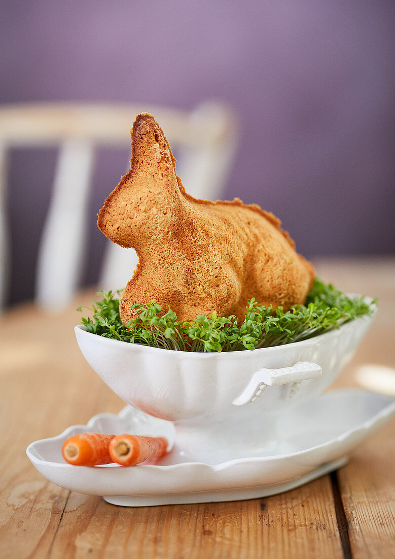 An Easter bunny cake on a bed of cress as a table decoration