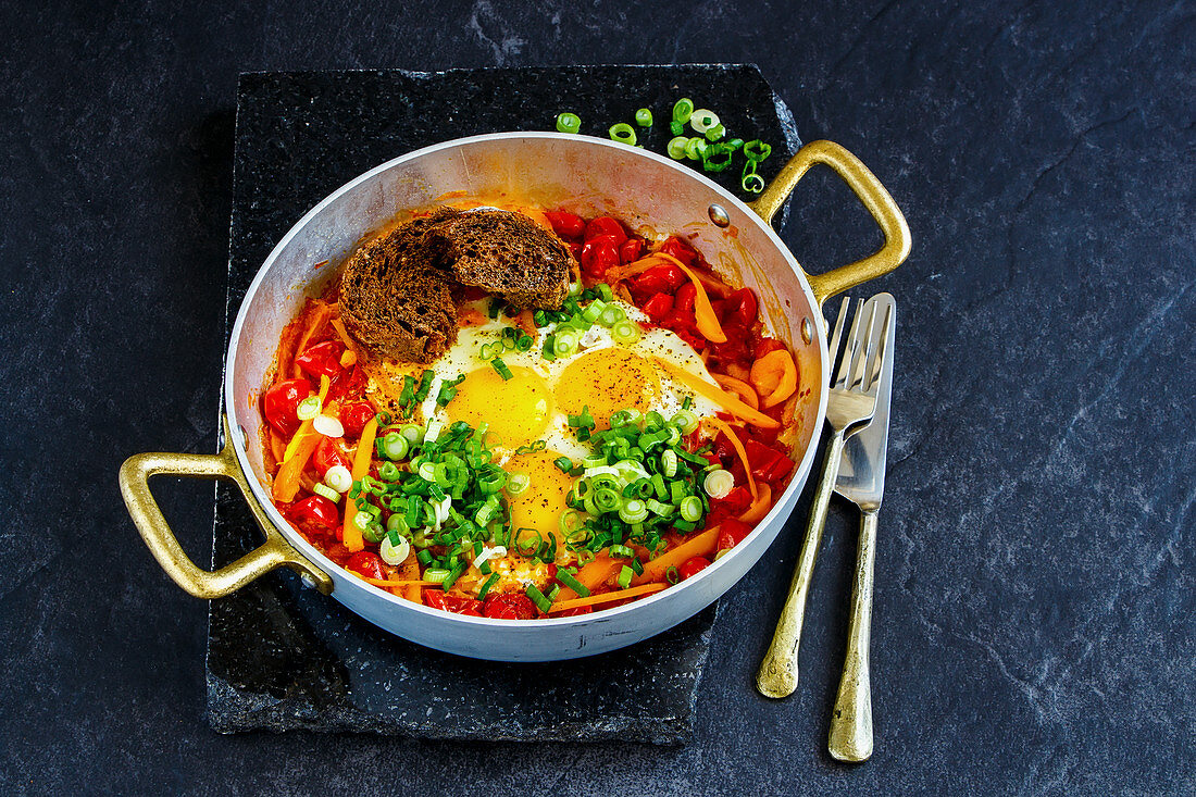 Shakshuka Fried eggs and tomatoes in frying pan