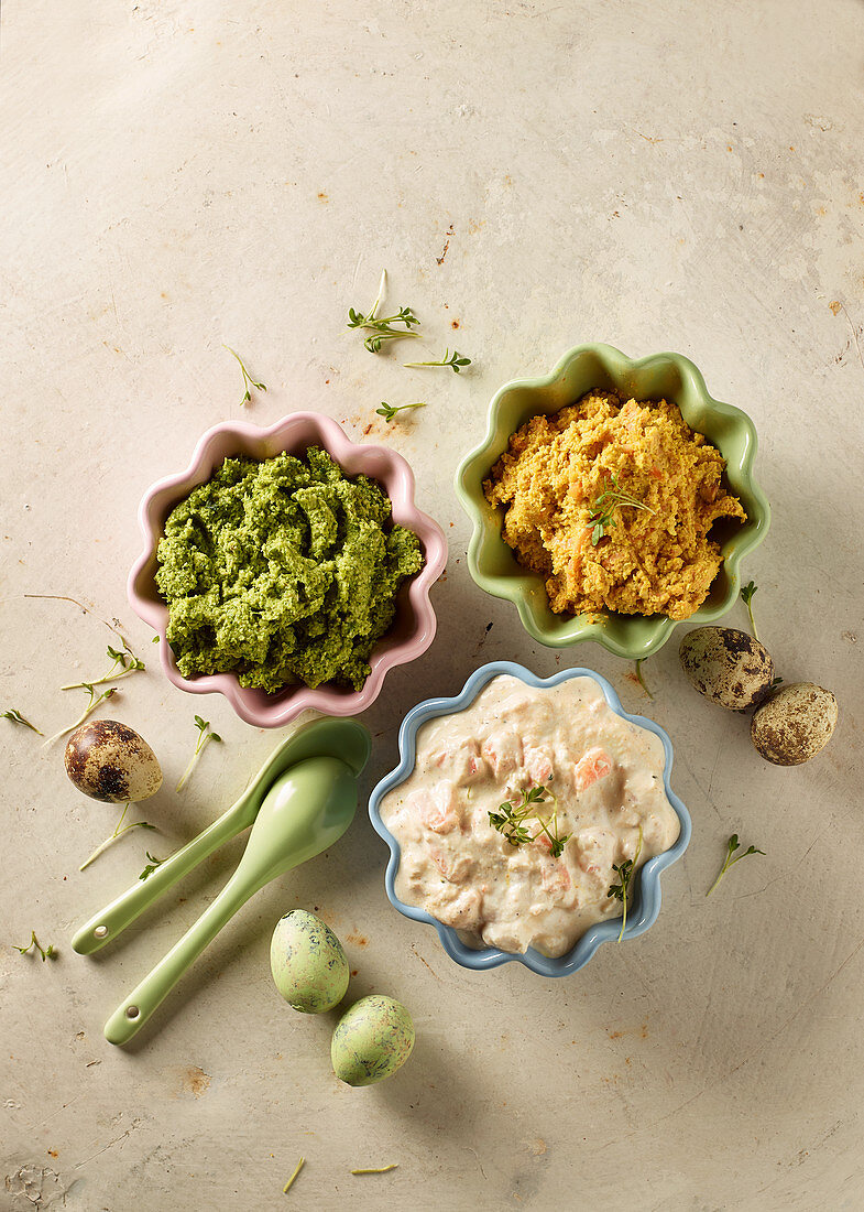 Three savoury spreads with quail's eggs and spoons