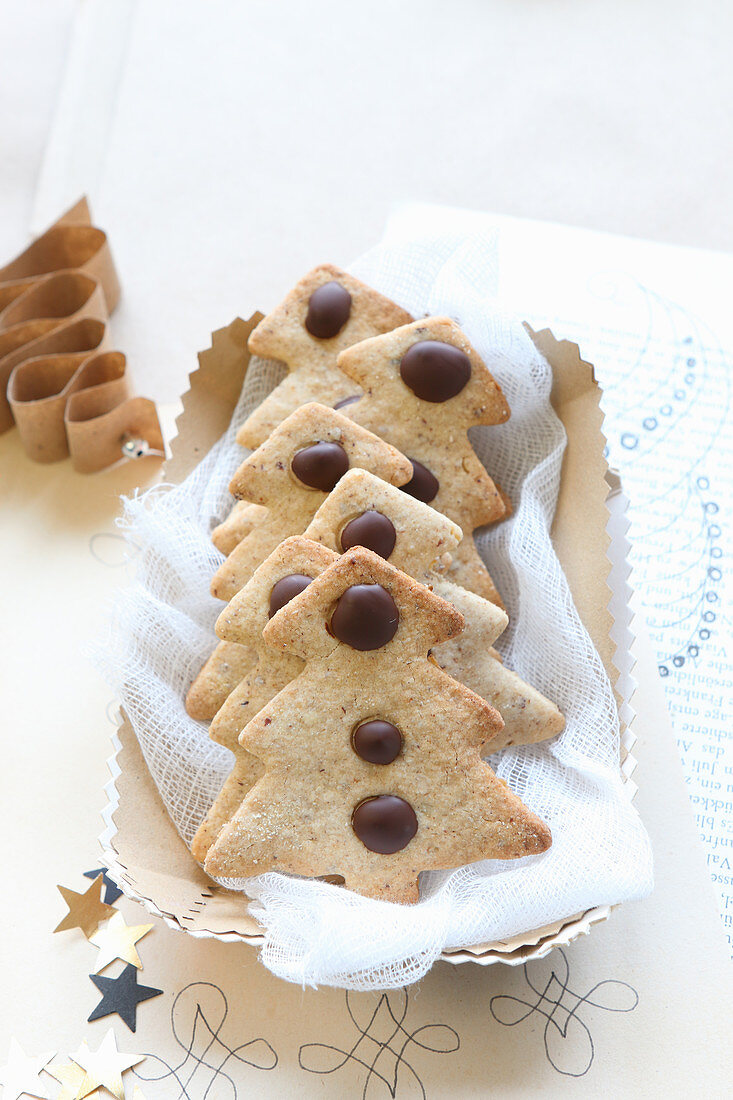 Gluten-free shortbread biscuits shaped like Christmas trees with chocolate drops