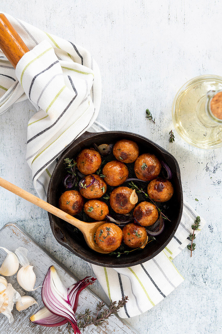 Vegan 'meatballs' with garlic and onions in a pan