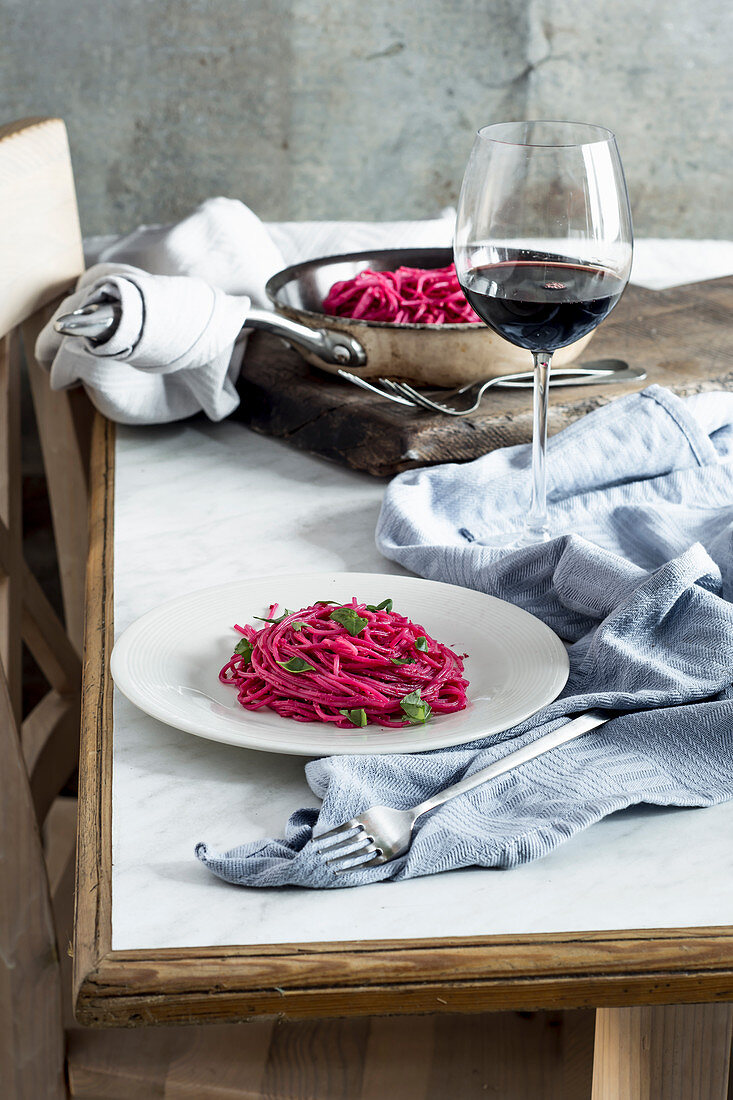 Spaghetti with beetroot pesto served with red wine