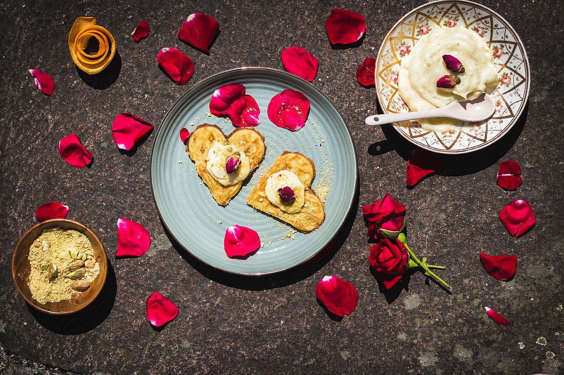 Heart-shaped waffle with pistachios, rose cream and rose petals
