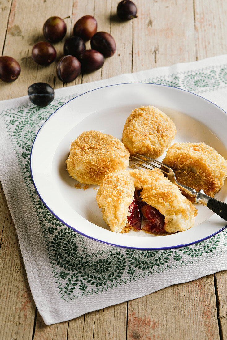 Damson dumplings on an enamel plate