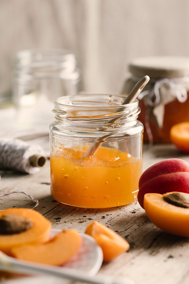 Apricot jam in jar with spoon