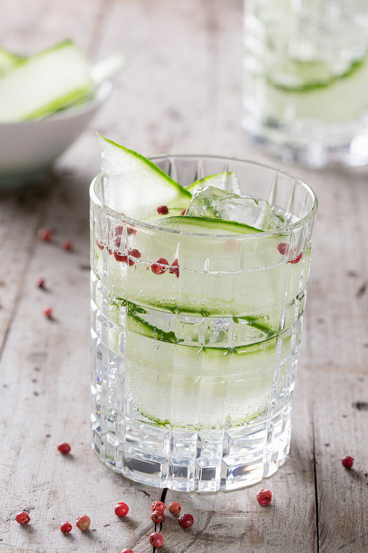 A Gin & Tonic with cucumber and pink peppercorns