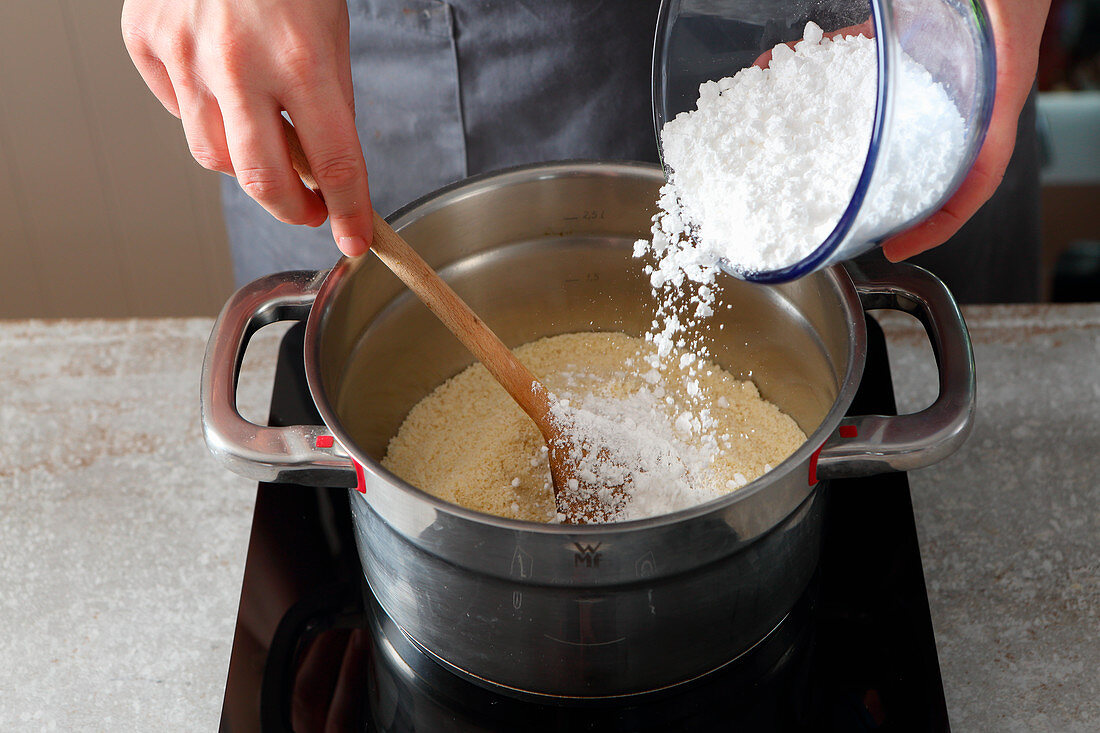 Marzipan being made: ground almonds being mixed with icing sugar