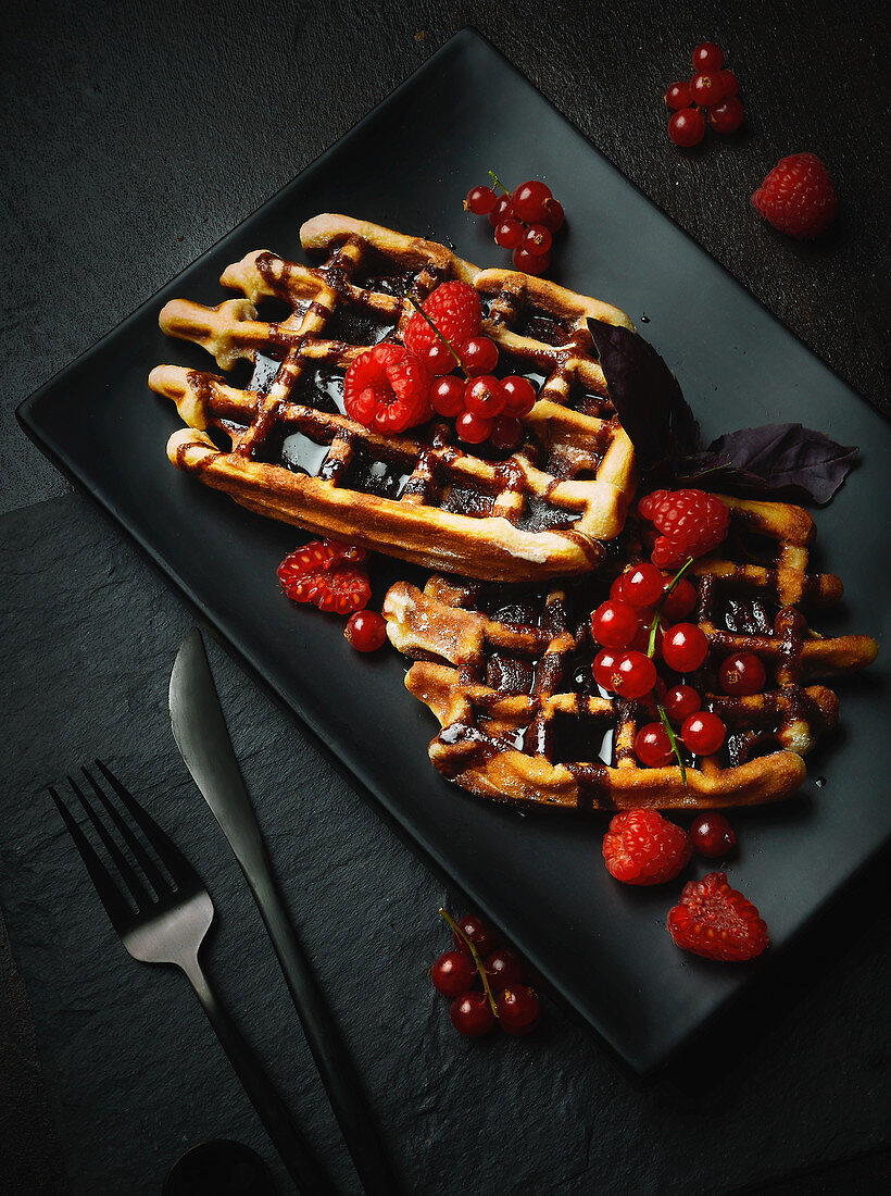 Waffles with chocolate sauce and fresh berries