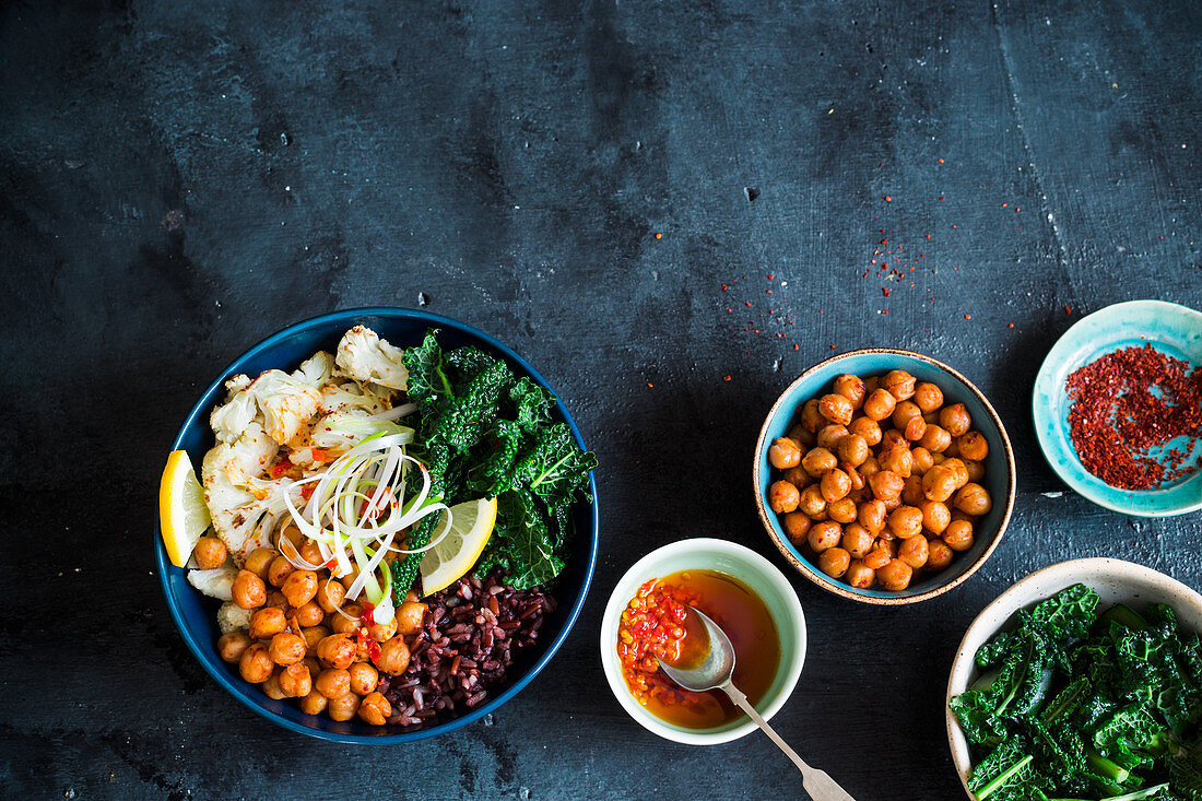 Vegan bowl with roasted spicy chickpeas, kale, wild rice and roasted cauliflower