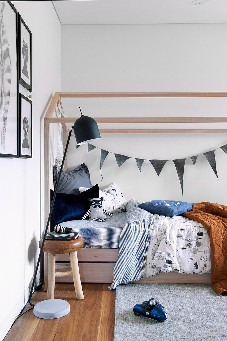 Modern wooden four poster bed in boy's room