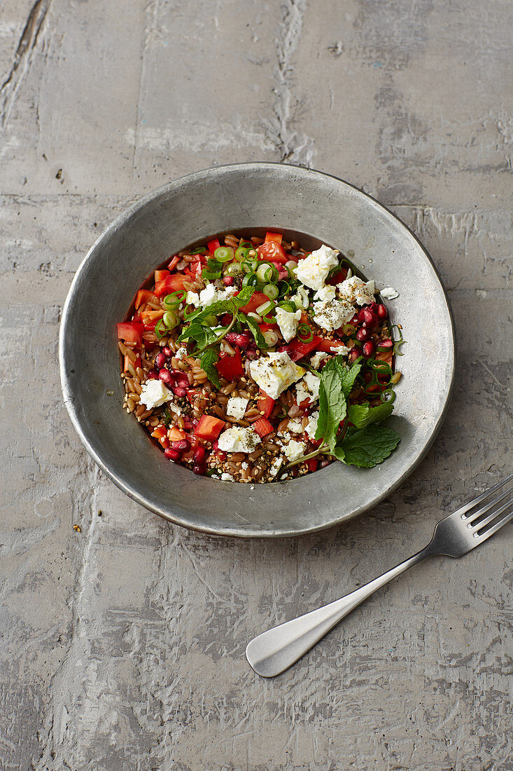 Freekeh salad with pomegranate seeds and feta cheese