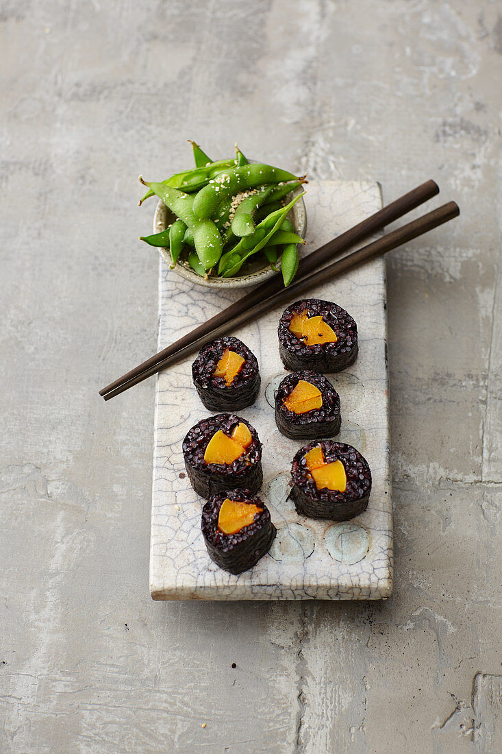 Pumpkin sushi with black rice served with edamame