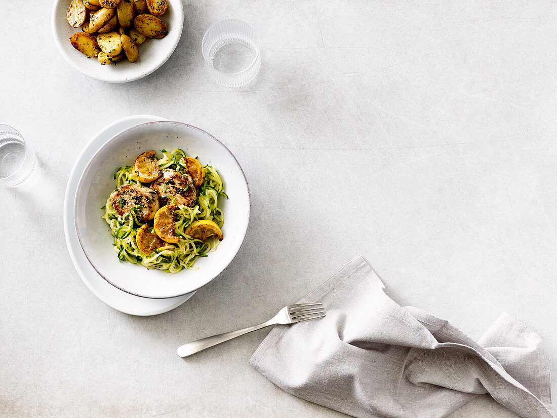 Herb pork medallions with courgette noodles and potatoes