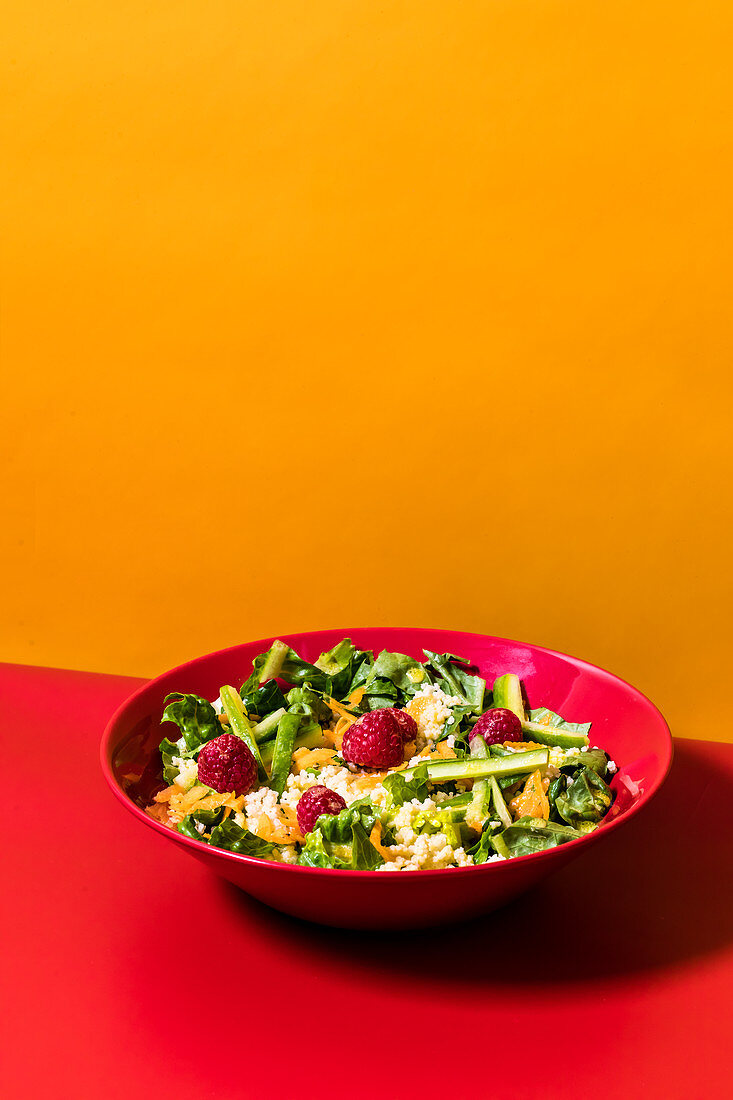 A summer couscous salad with raspberries and vegetables