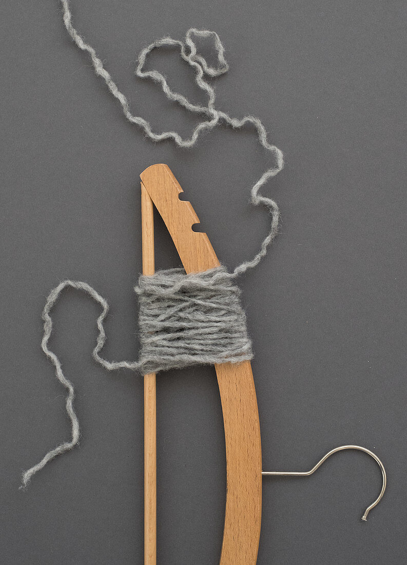 A gauge being unravelled using a clothes hanger