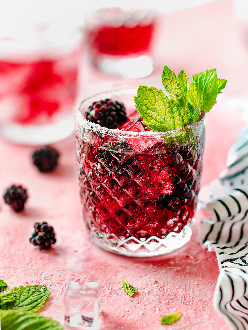 Blackberry bourbon smash with mint leaves and ice cubes