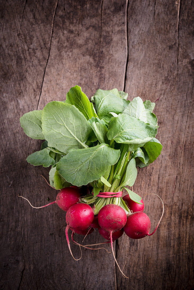 A bunch of radishes on a wooden background