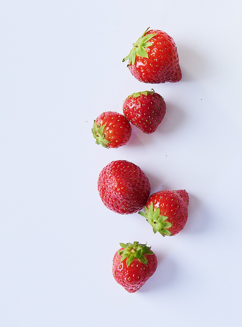 Strawberries on a white surface