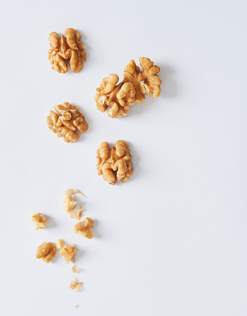 Walnuts on a white surface