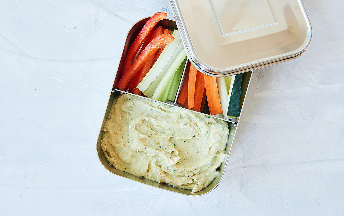 Vegetable crudités with bean hummus in a lunch box