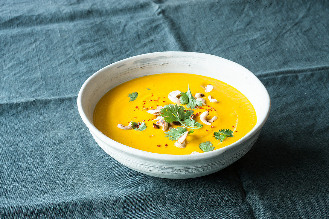 Vegan carrot and ginger soup with cashew nuts
