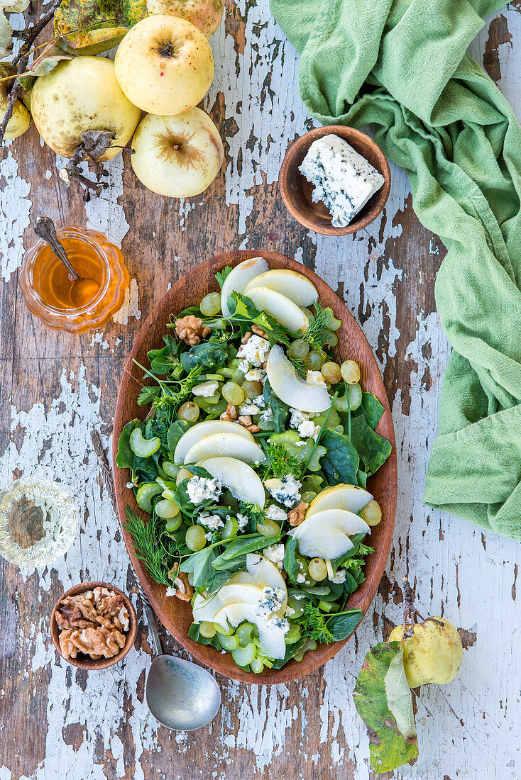 Green herb and vegetable salad with apple, grapes, walnuts and blue cheese