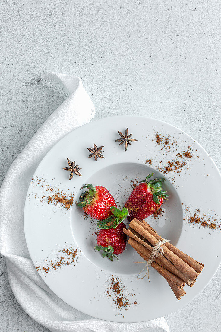 Red and fresh strawberries with cinnamon and mint