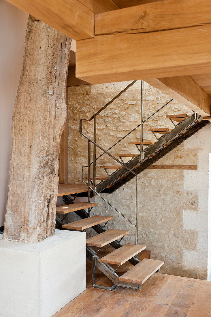 Staircase leading to gallery in converted, renovated barn