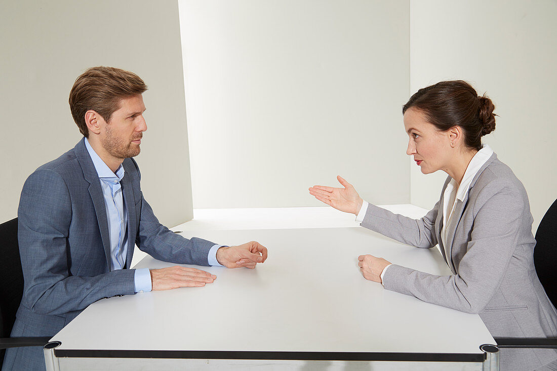 A man and a woman having a business conversation