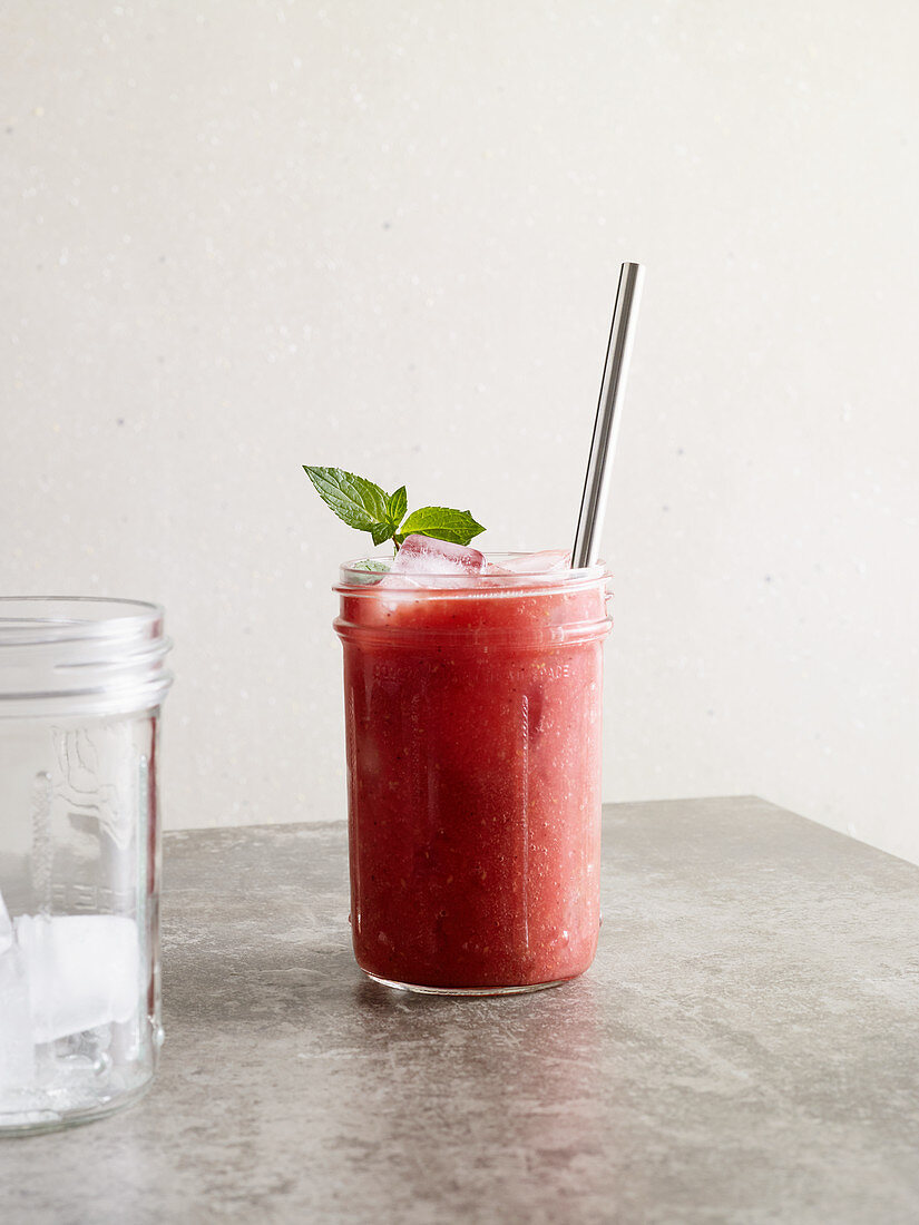 A watermelon and mint freezy with raspberries, dates and honey