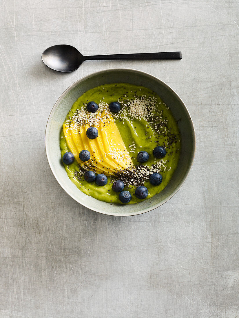 A green smoothie bowl with chia, avocado and blueberries