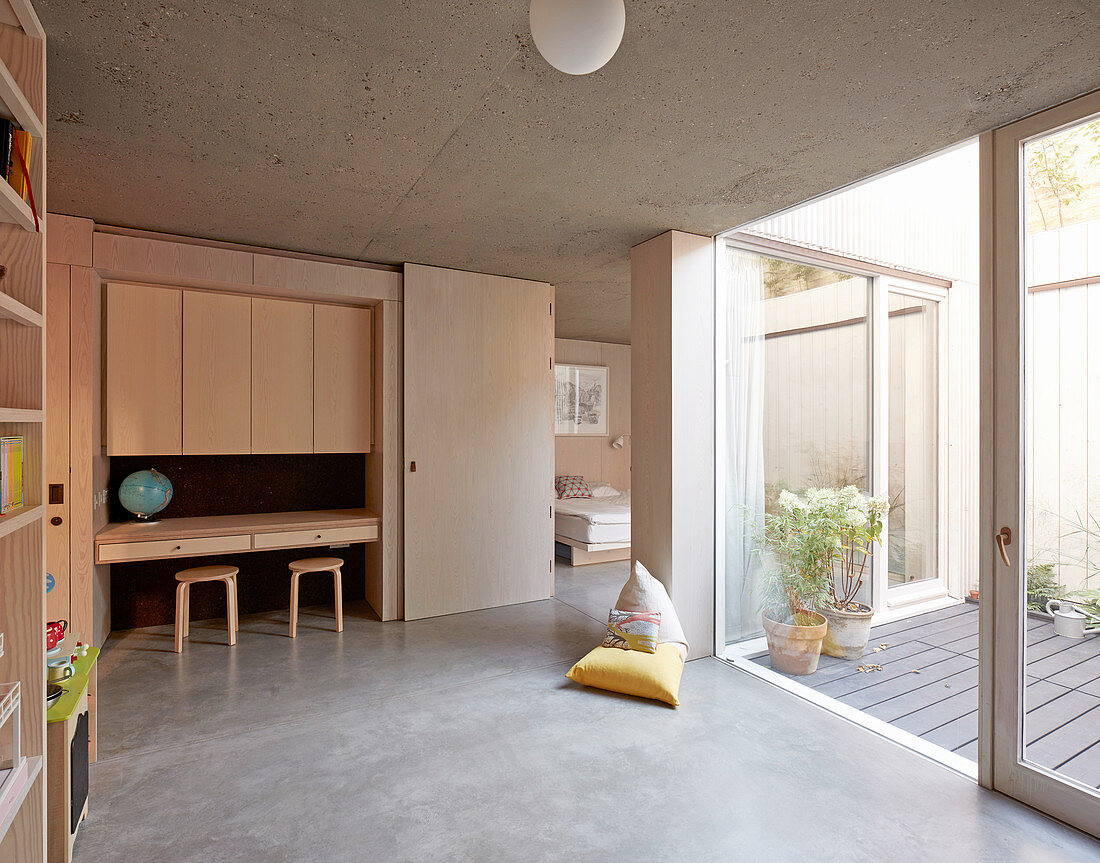 Wooden fitted furnishings in child's bedroom with access to terrace