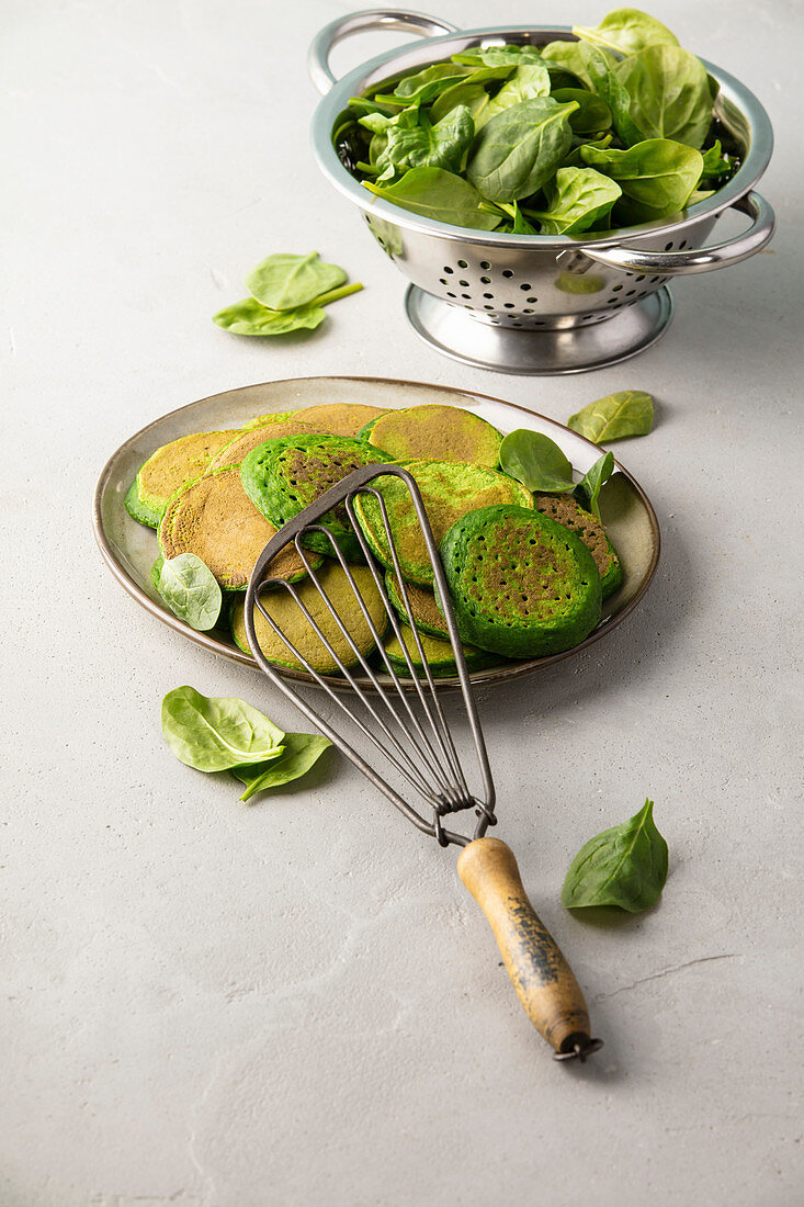 Homemade spinach pancakes on concrete background