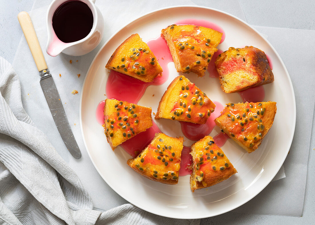 Pieces of yoghurt and passionfruit cake drizzled with rosehip syrup