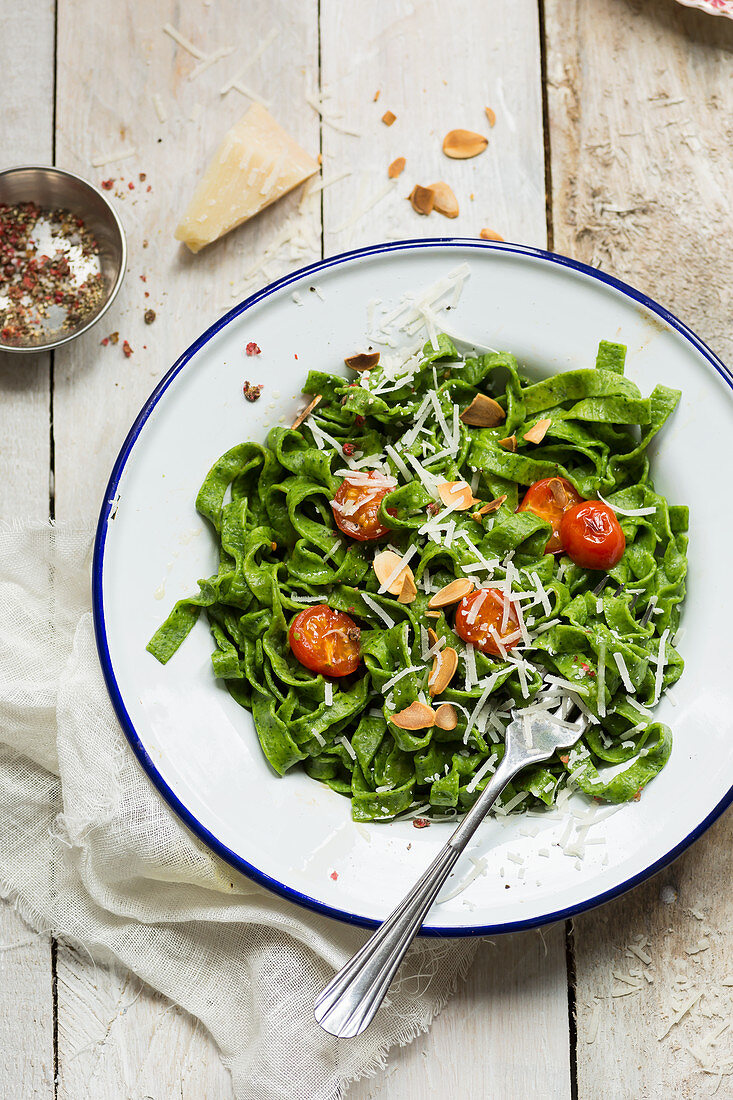 Spinach pasta with tomato, parmesan and toasted almonds