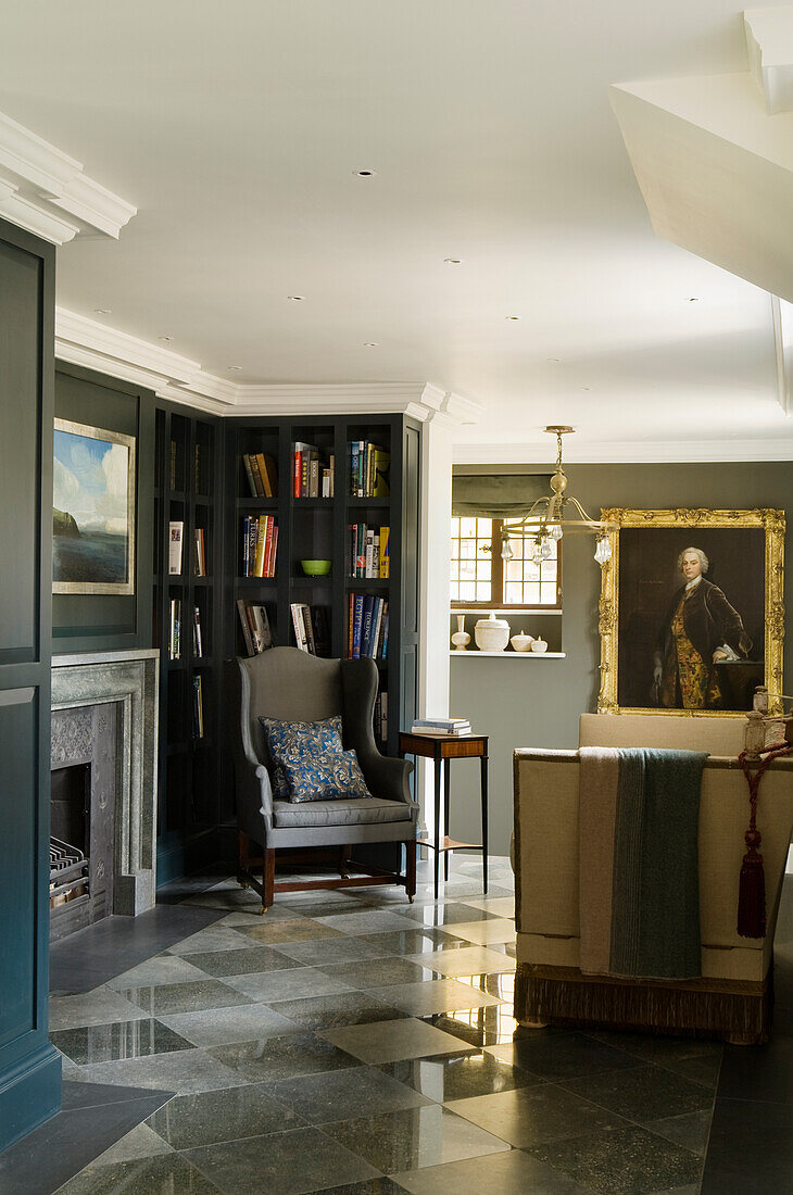 Library with purbeck marble floor and wingback armchair