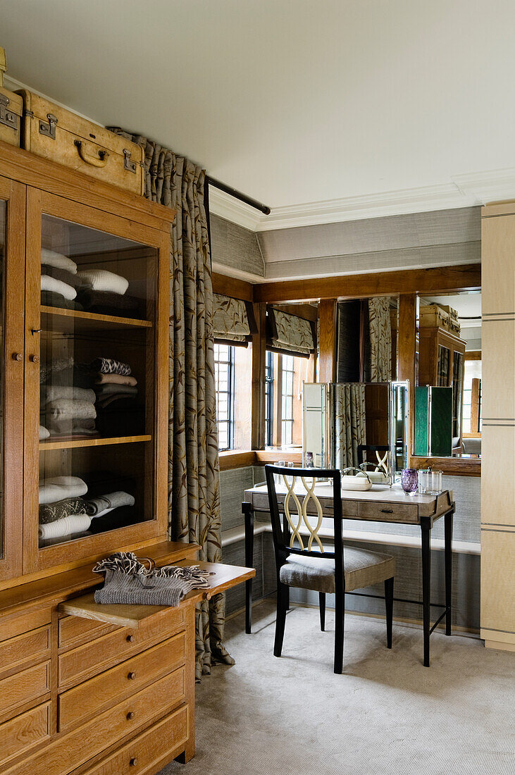 Dressing room with large oak cabinet and antique dressing table