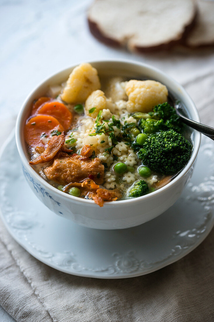 Vegan noodle soup with vegetables and fried soy pieces