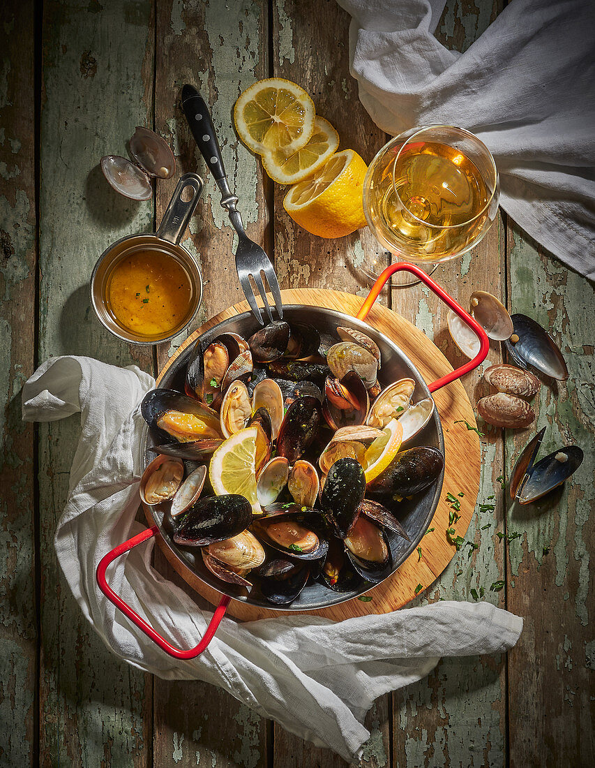 A pan of mussels with lemon slices