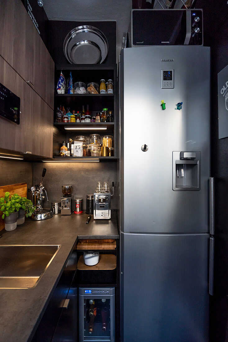 Tall fridge-freezer in small, grey, masculine kitchen