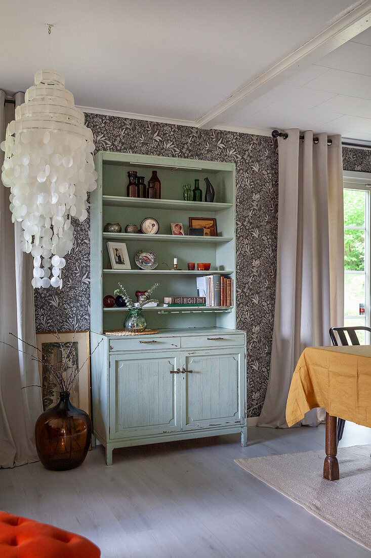 Mint-green shabby-chic dresser in open-plan interior