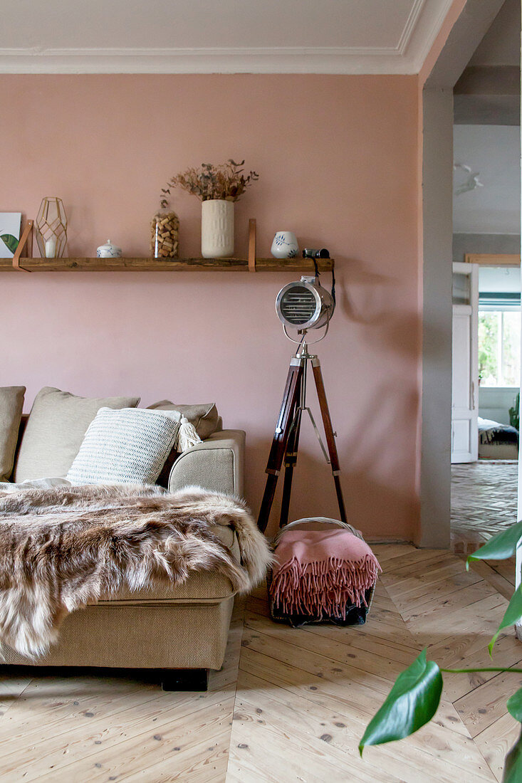 Old studio lamp against pink wall in living room