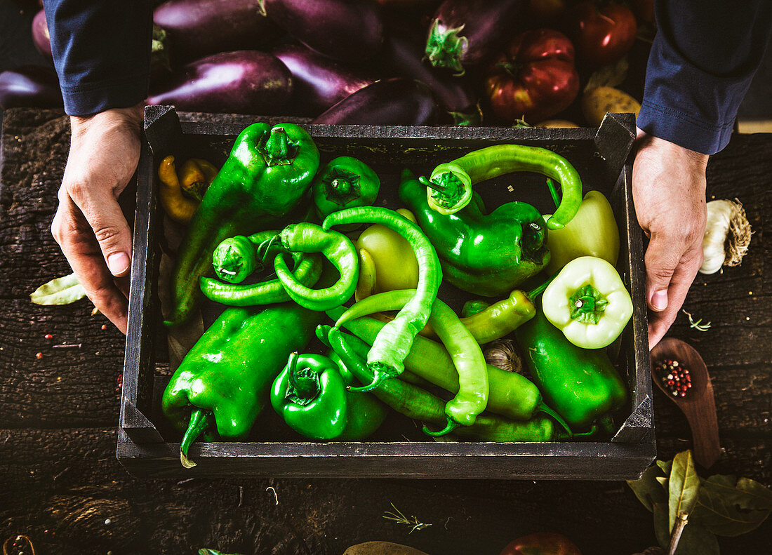 Farmers hands with green peppers