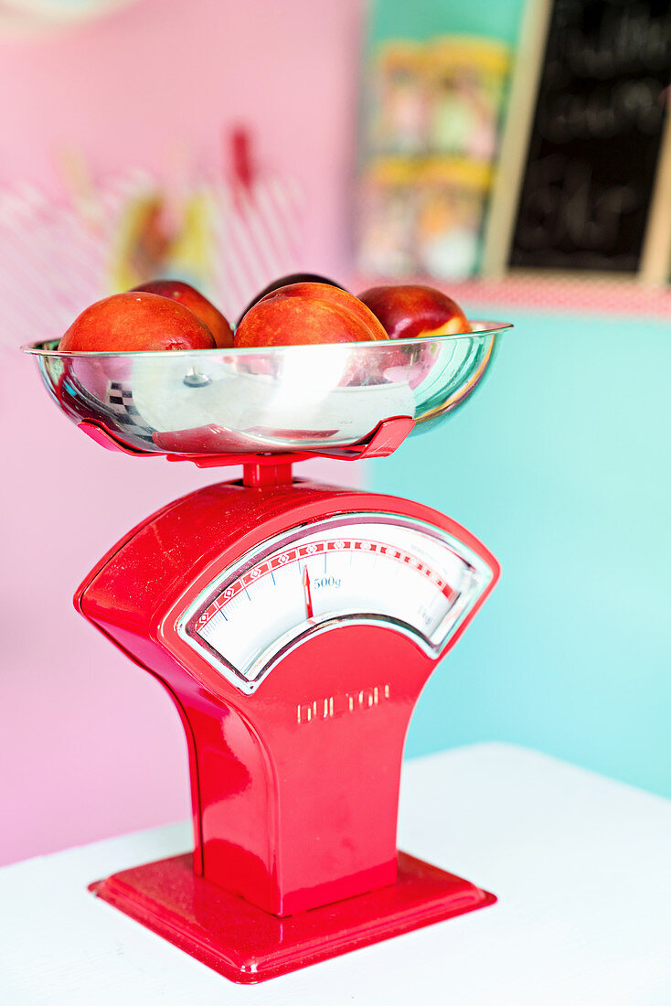 Fruit on red kitchen scales