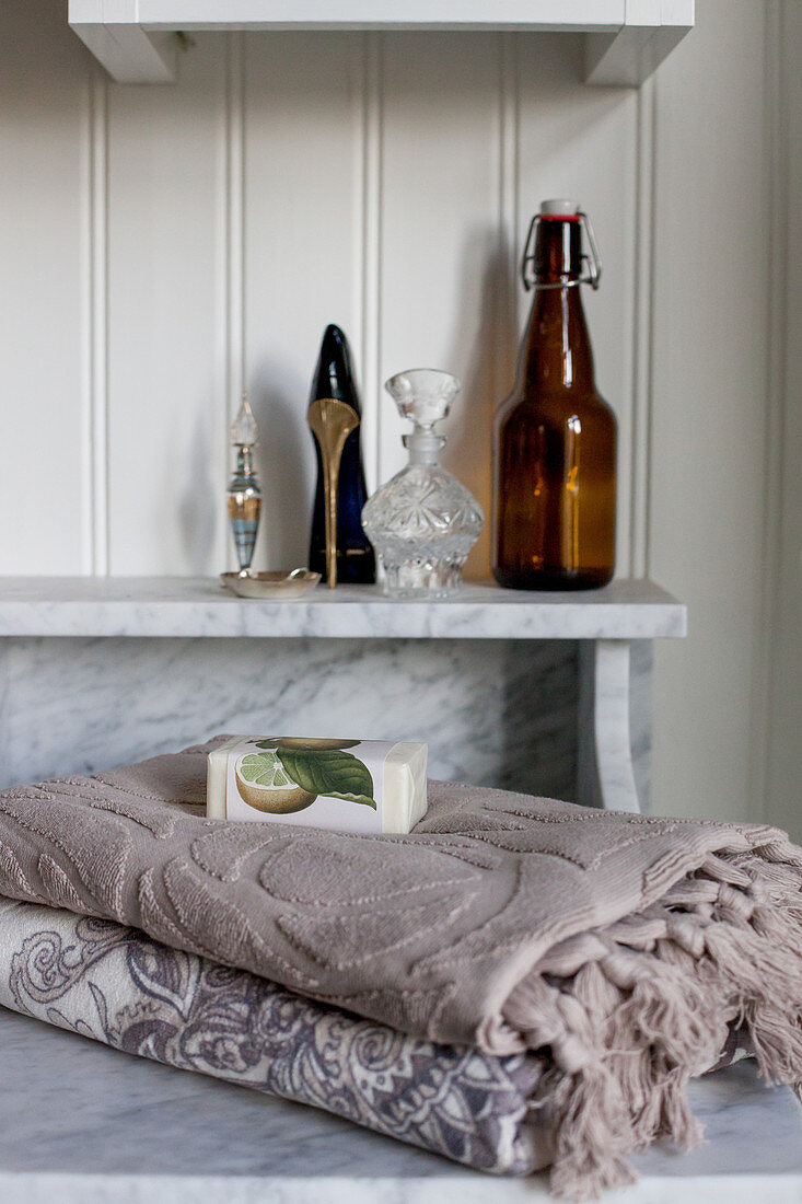 Towels and bar of soap on marble washstand