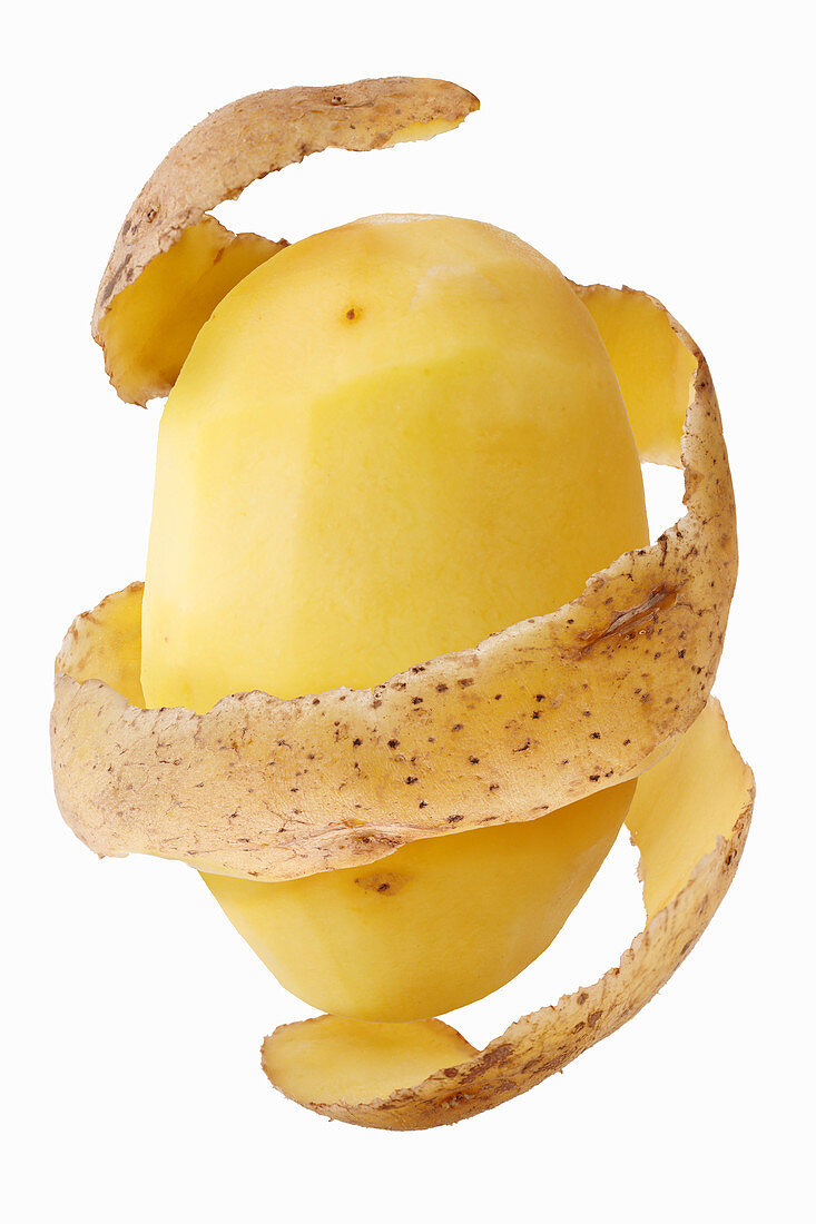 A peeled potato with potato peel