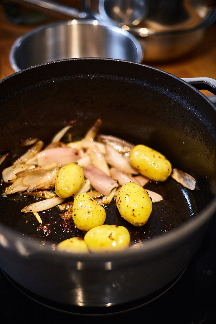 Lemon chicken with shallots being made