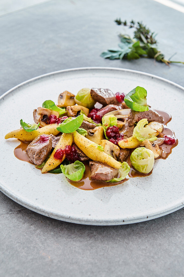 Venison with potato orzo pasta and Brussels sprouts