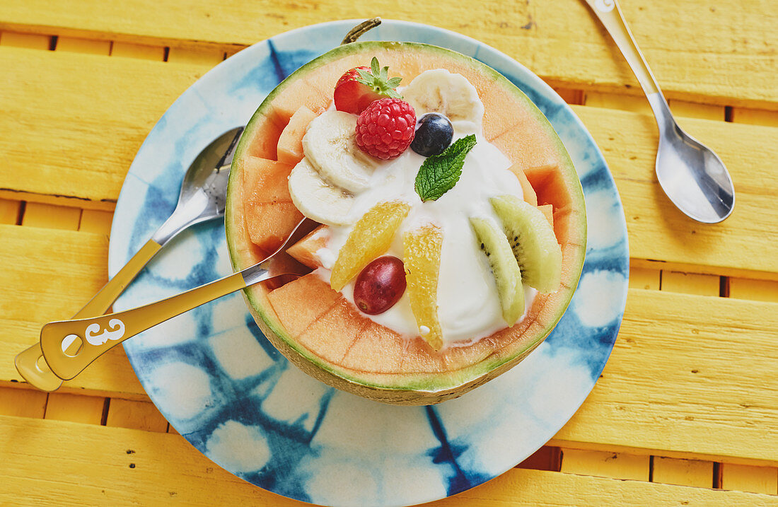 A musk melon filled with Greek yoghurt and fruit