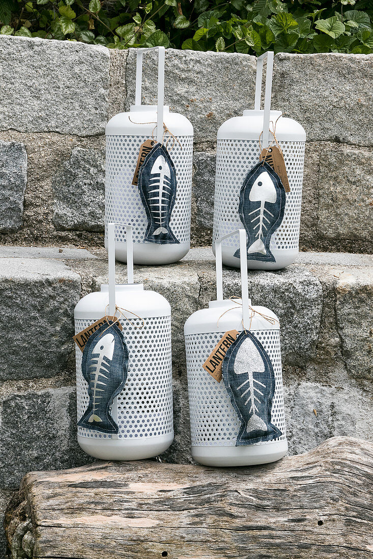 Hand-sewn denim fish ornaments with silver skeletons